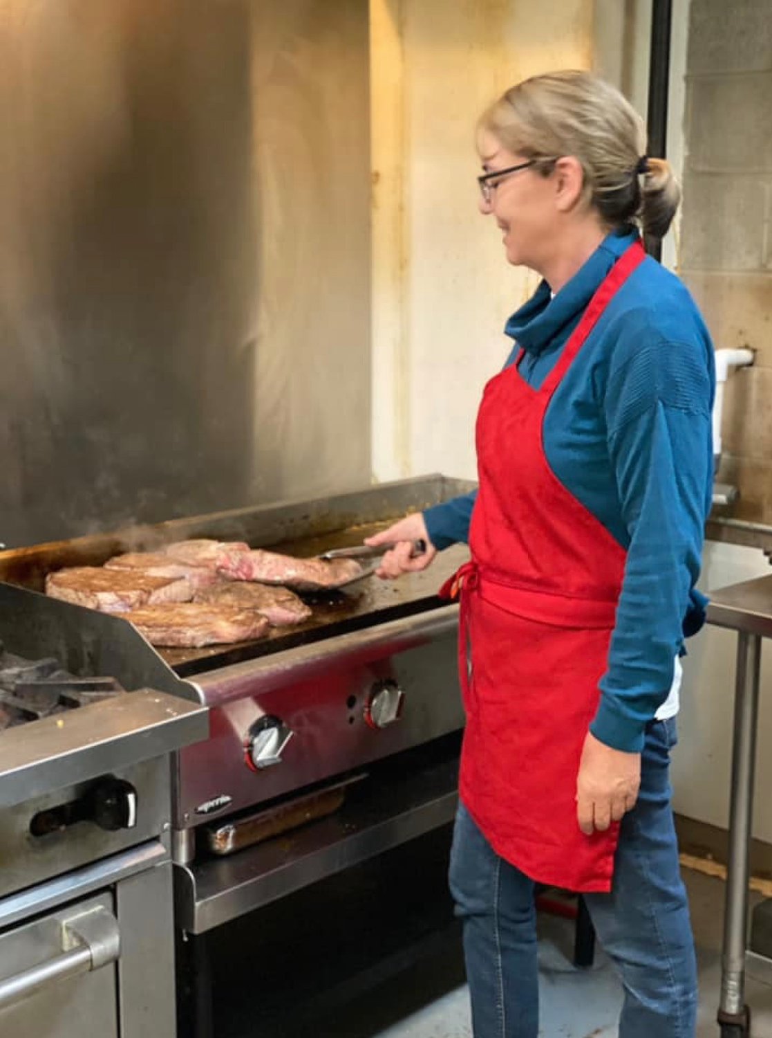 Anne Myers works at the griddle of Annie M’s Café that opened recently on U.S. 49 in Flora.